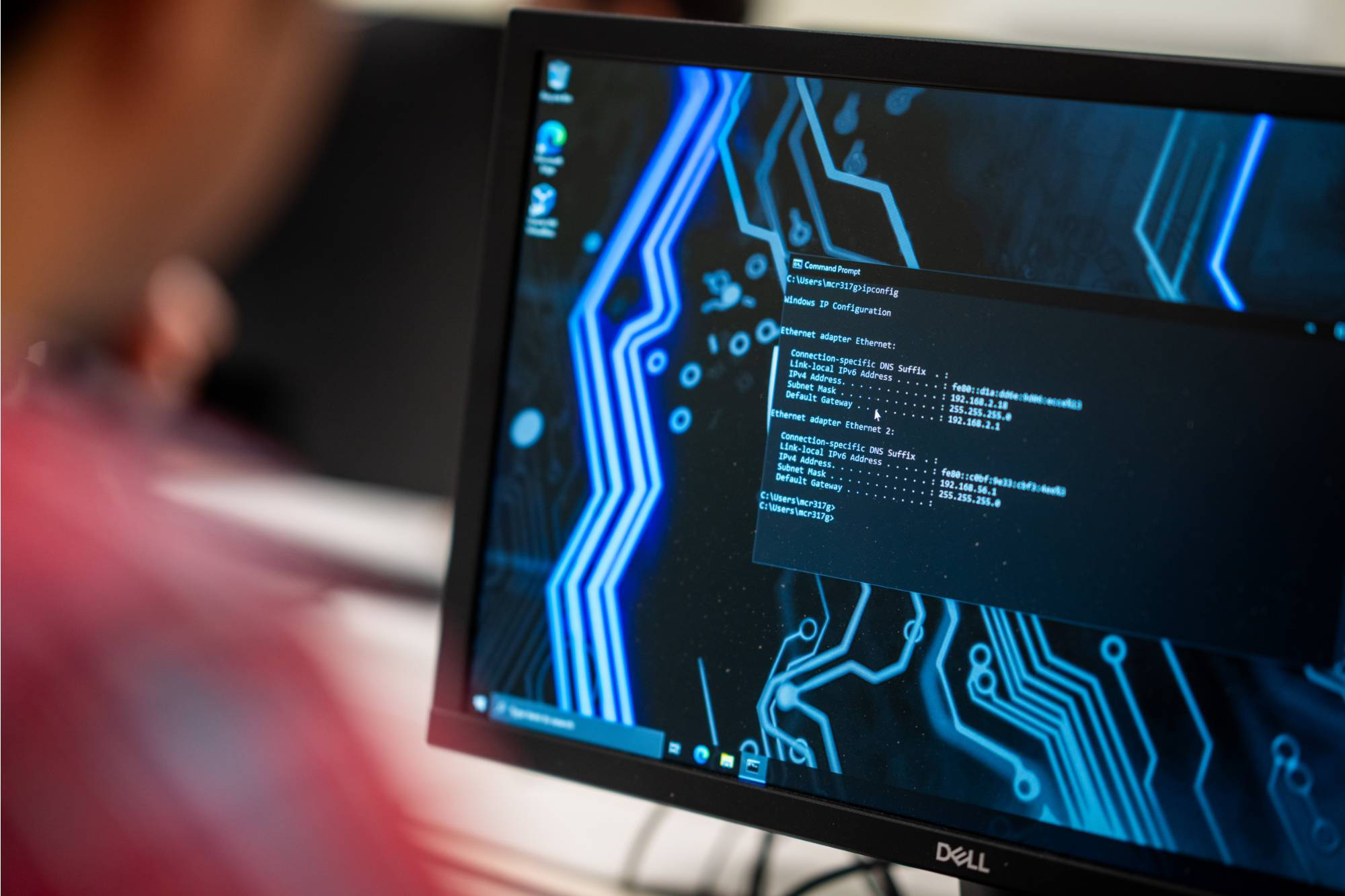 Students working together on a hands-on computing project in a lab setting, with a caption describing Grand Valley State University's School of Computing offering knowledge and real-world experience to undergraduates in a tech-driven world, fostering inno